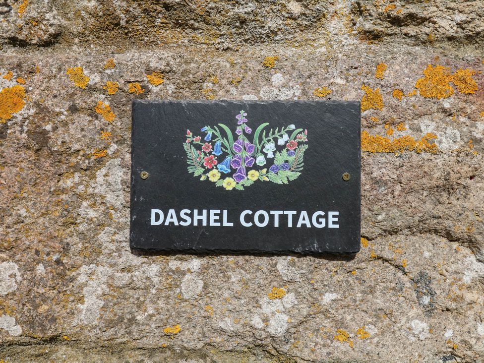 A slate sign with the text Dashel Cottage at Dockwell Farm near Widecombe-In-The-Moor
