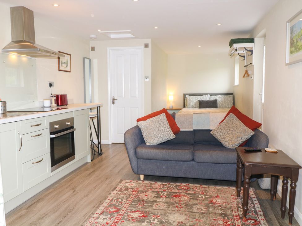 A studio apartment with a kitchen and bed area at Lodgeview Nottingham
