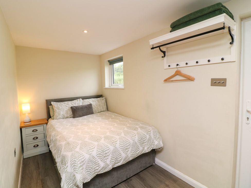 A bedroom with a bed and nightstand at Lodgeview Nottingham