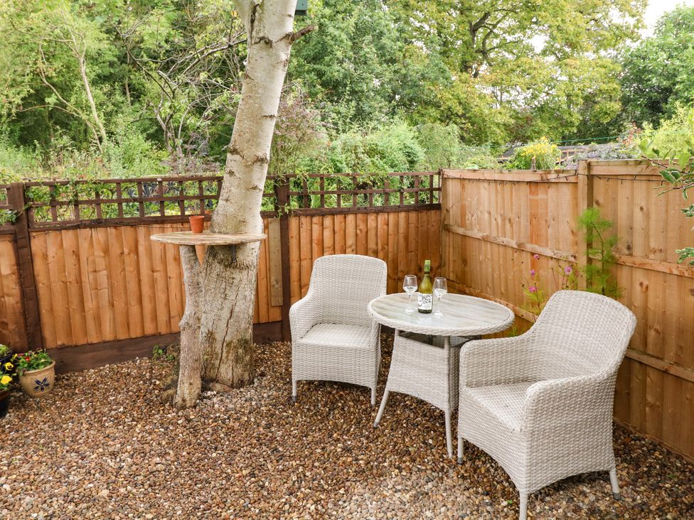 A garden with a tree and seating area at Lodgeview Nottingham