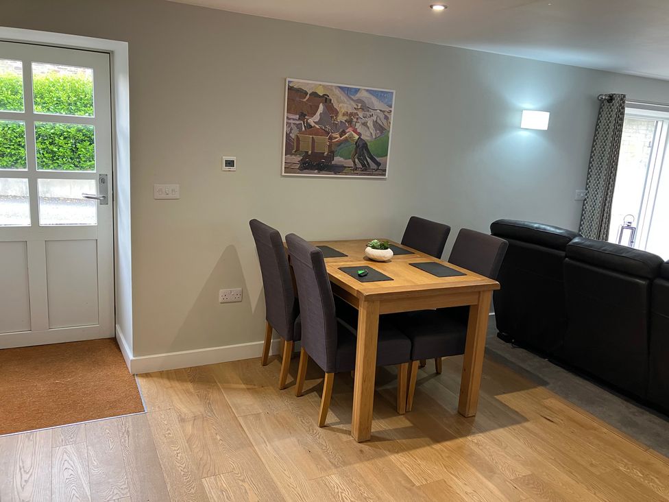 A dining area with a table and chairs at The Old Dairy near Liskeard
