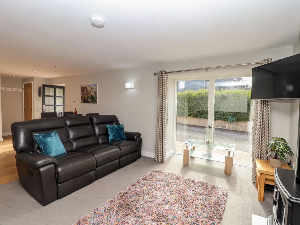 A living room with a sofa and coffee table at The Old Dairy near Liskeard