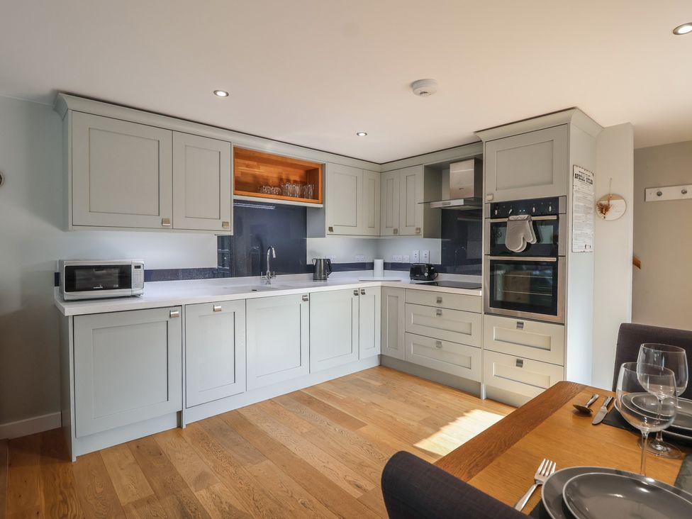 A kitchen with cabinets and appliances at The Old Dairy near Liskeard
