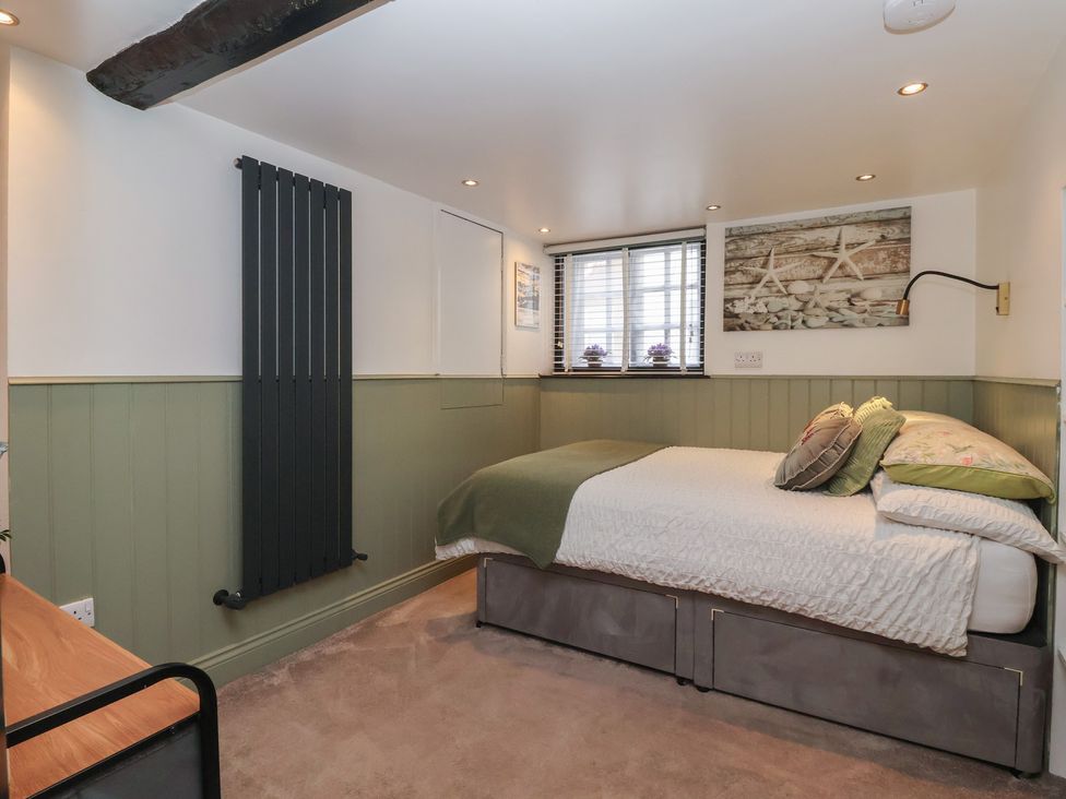 A bedroom with a bed and radiator at Cathedral Mews in Ripon