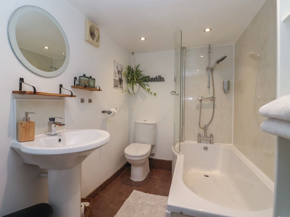 A bathroom with a bathtub, sink, and shower at Cathedral Mews in Ripon