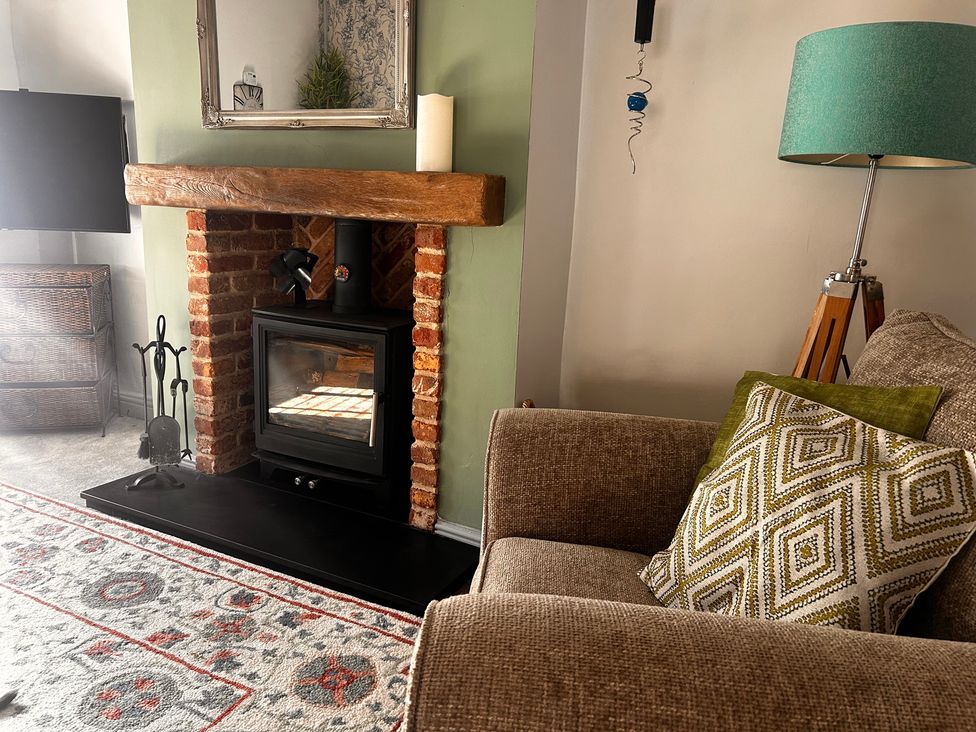 A living room with a fireplace and television at Old Cottages: 3 Bed Ripon