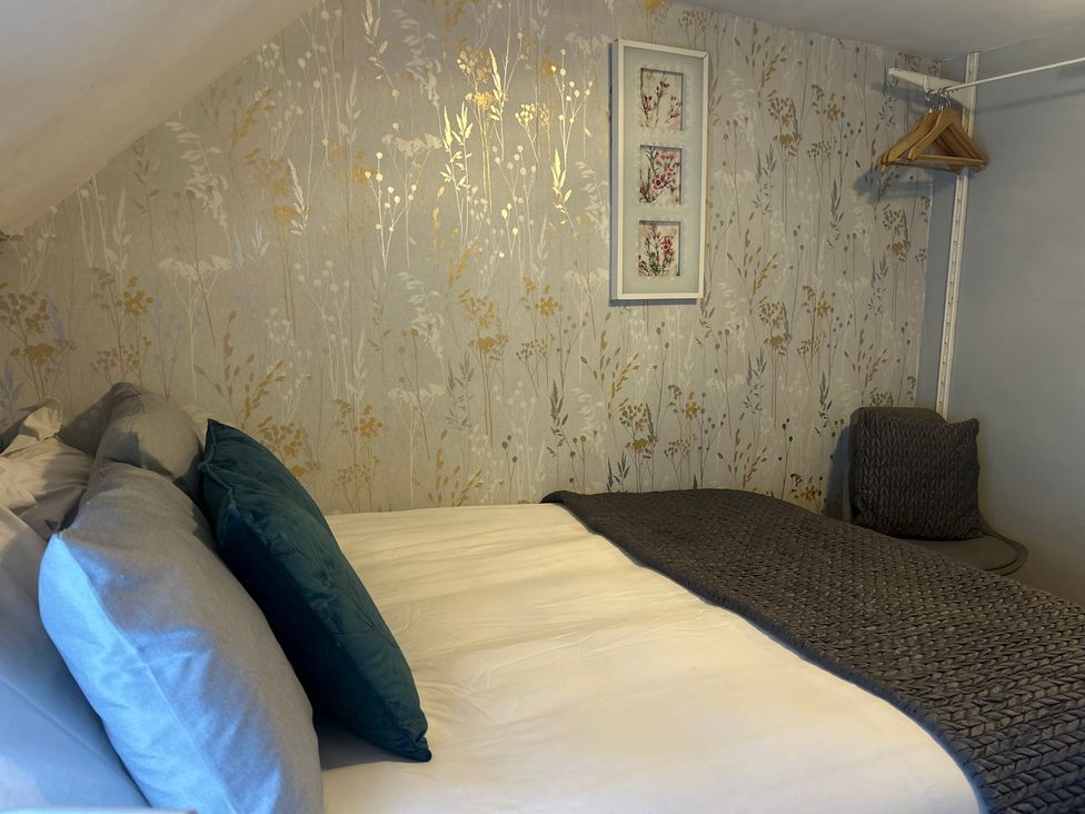 A bedroom with bed and wall art at Old Cottages: 3 Bed in Ripon
