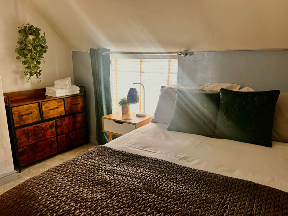 A bedroom with a bed and window at Old Cottages: 3 Bed in Ripon