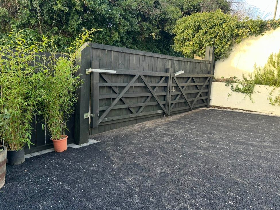 A gate with potted plants and gravel surface at Old Cottages: 3 Bed in Ripon