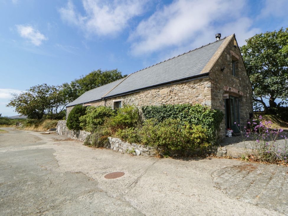 An exterior view of a stone building with a slate roof at May Cottage in St Davids