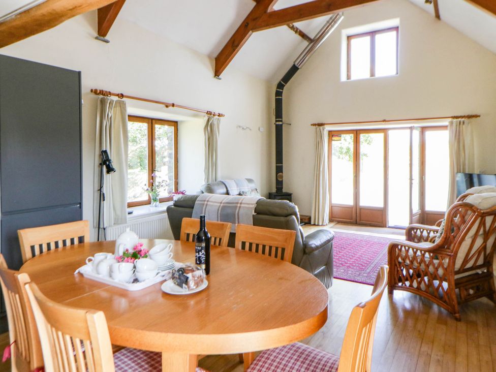 A living room with a table and chairs at May Cottage in St Davids