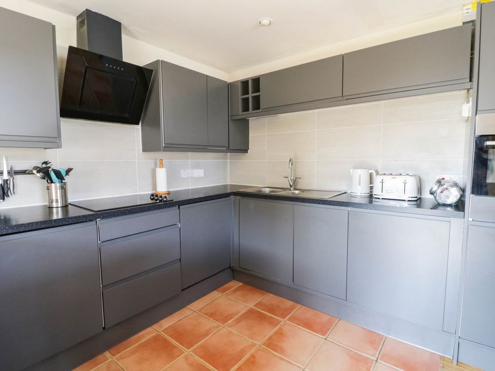 A kitchen with a sink, toaster, and kettle at May Cottage St Davids