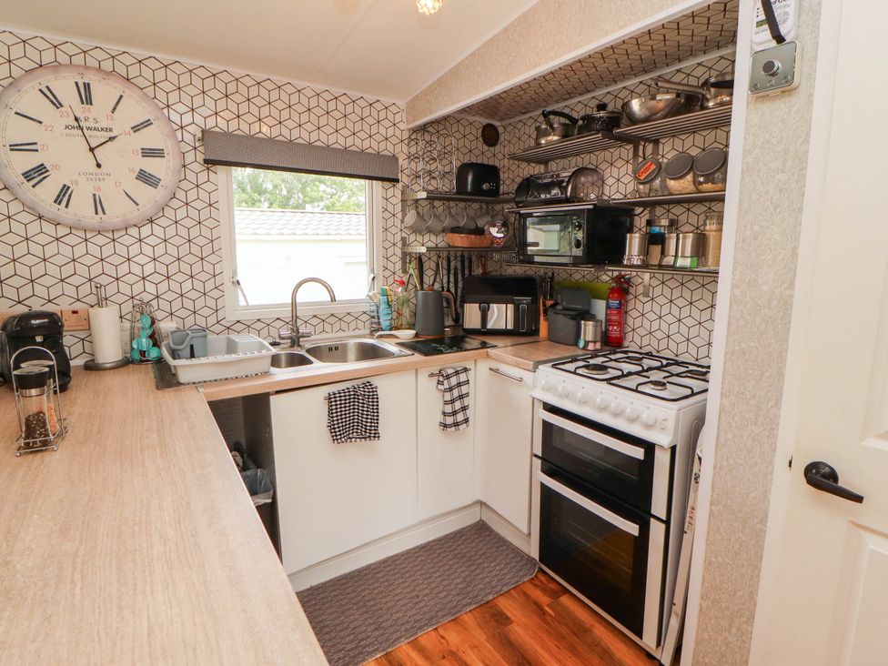 A kitchen with appliances and utensils at Summer Breeze in Clitheroe