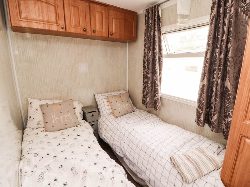 A bedroom with two single beds and cabinets at Summer Breeze in Clitheroe