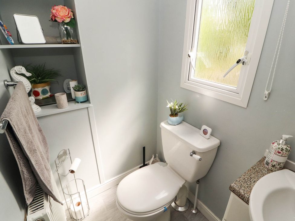 A bathroom with a toilet and a sink at Summer Breeze in Clitheroe