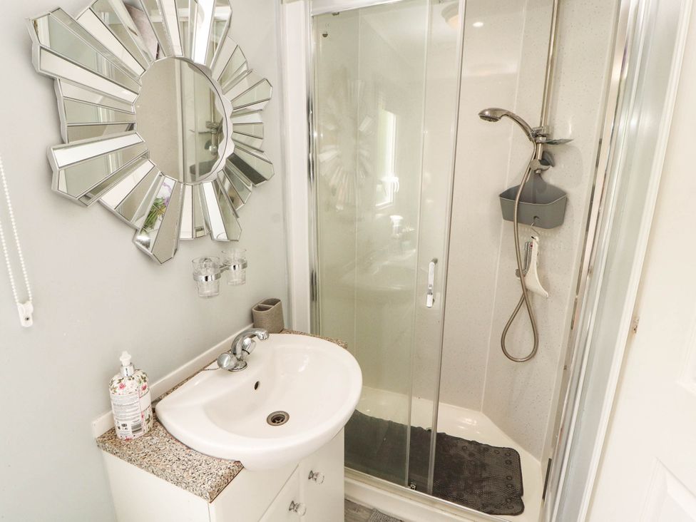 A bathroom with a sink and shower at Summer Breeze in Clitheroe