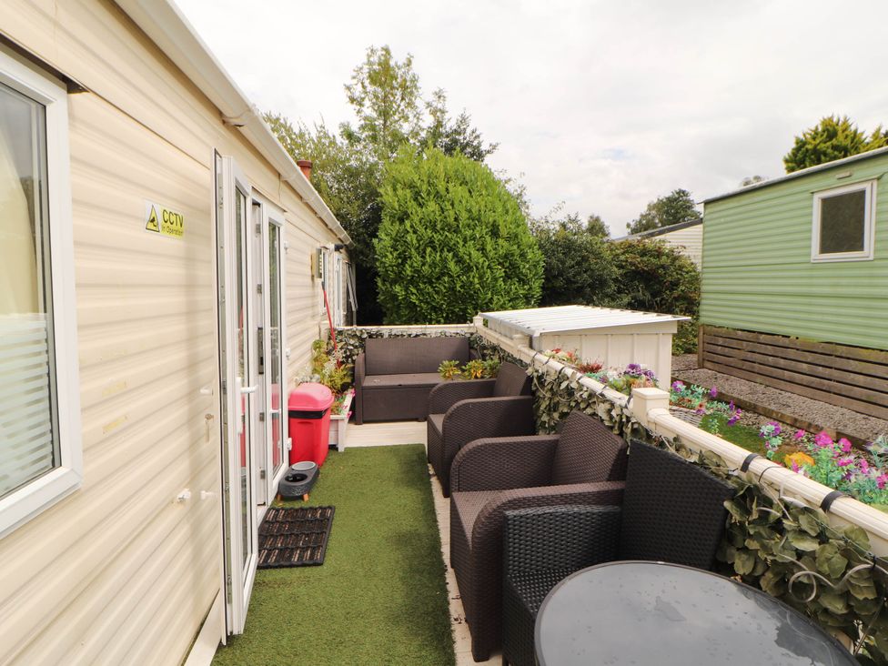 A patio area with seating and plants at Summer Breeze in Clitheroe