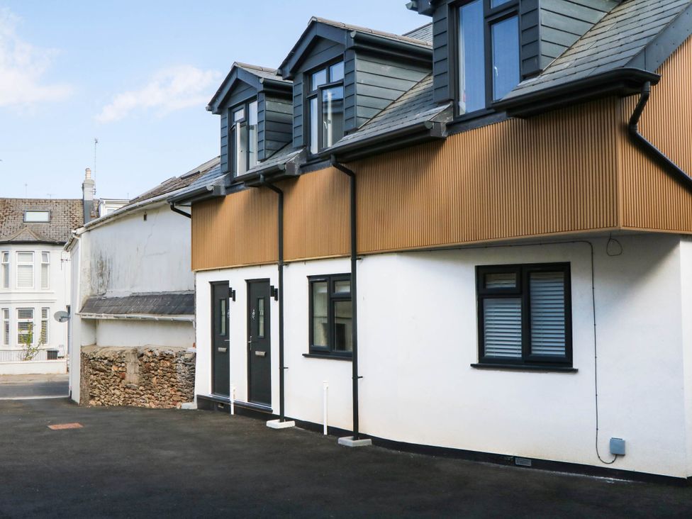 A house with multiple windows and doors at Greenswood Mews in Brixham