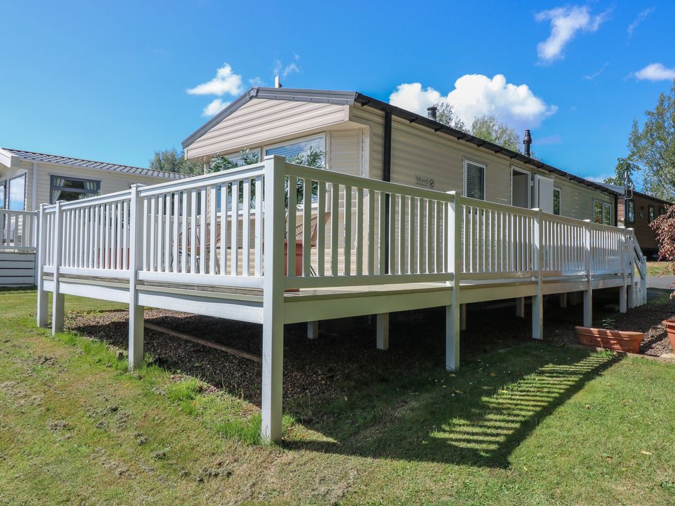 A mobile home with a deck and railing at NO. 249 Eyemouth
