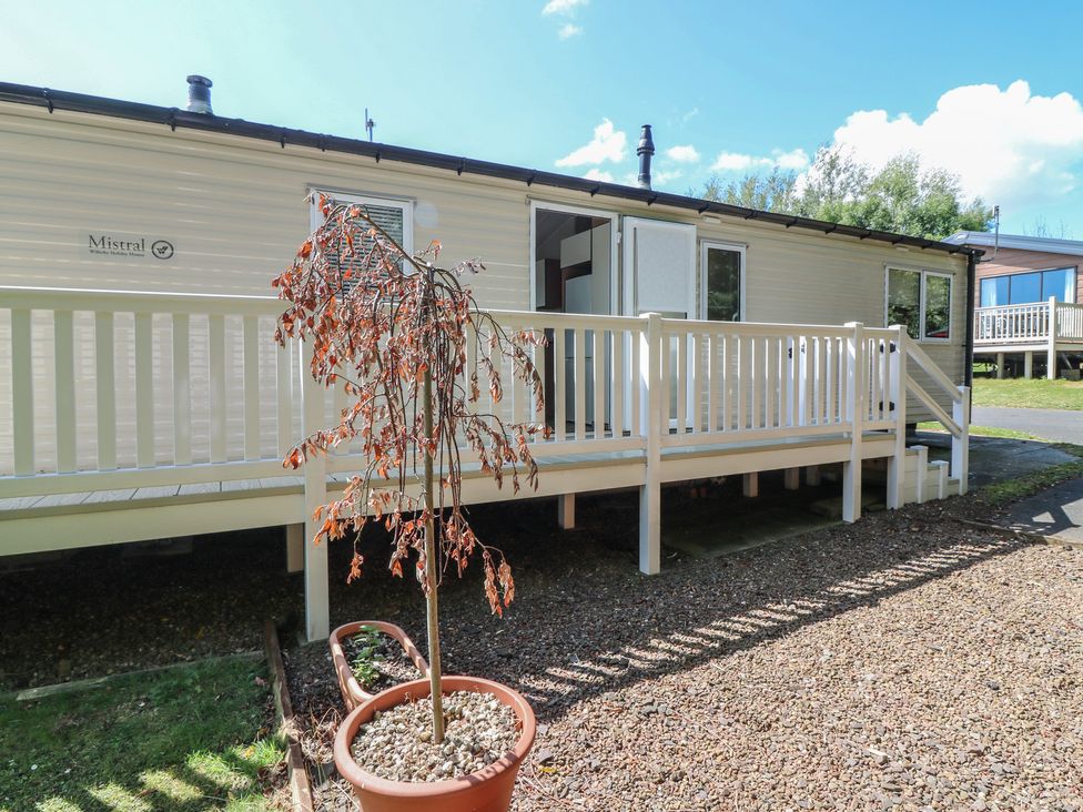 An outdoor view of a mobile home with a deck at NO. 249 Eyemouth