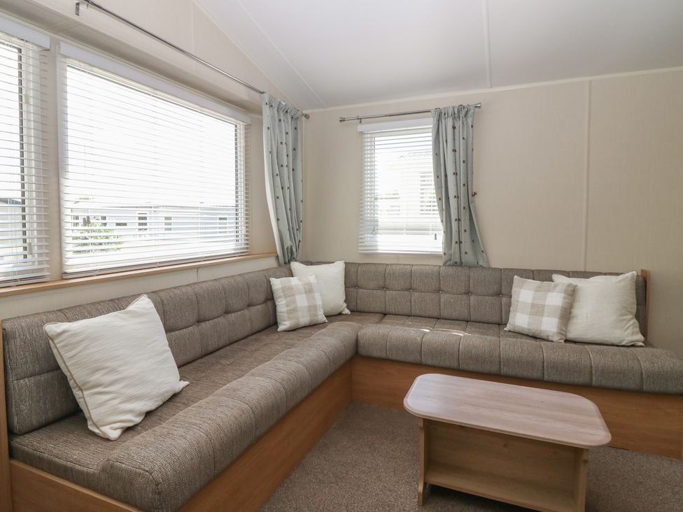 A living room with a corner sofa and a coffee table at NO. 249 in Eyemouth