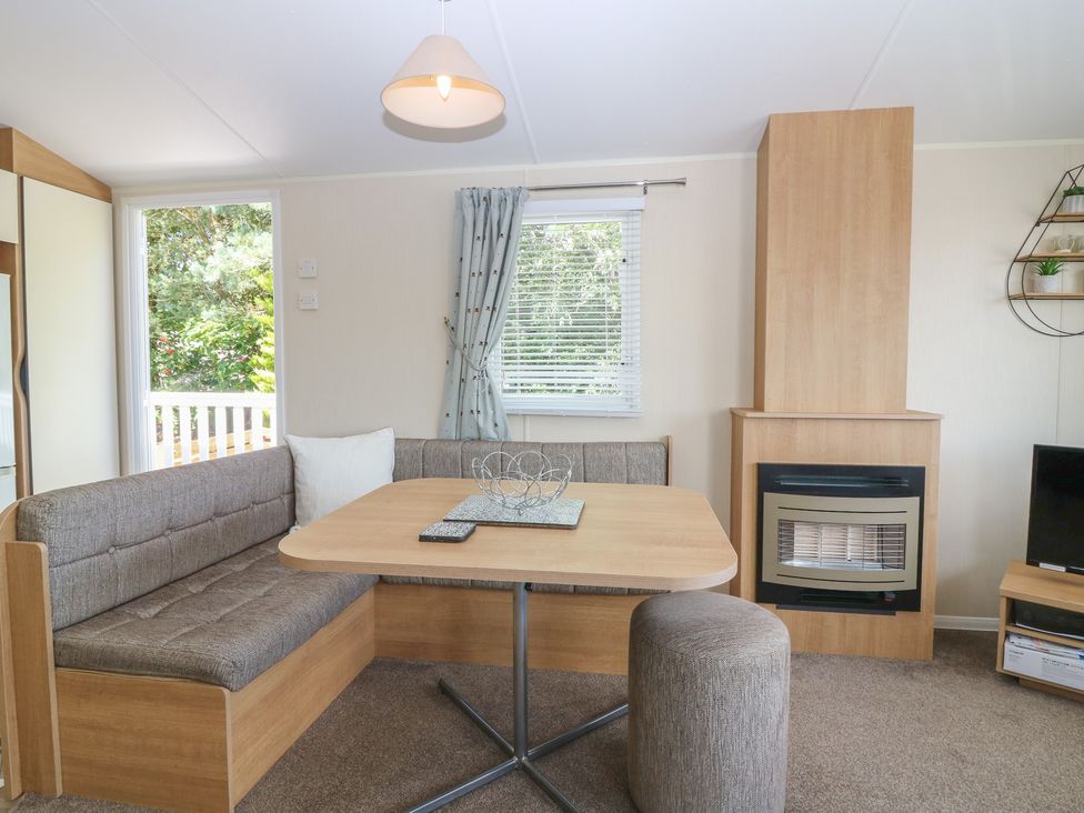 A living room with a table and sofa at NO. 249 Eyemouth