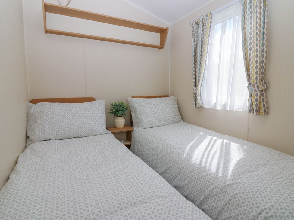 A bedroom with two beds and a window at NO. 249 Eyemouth