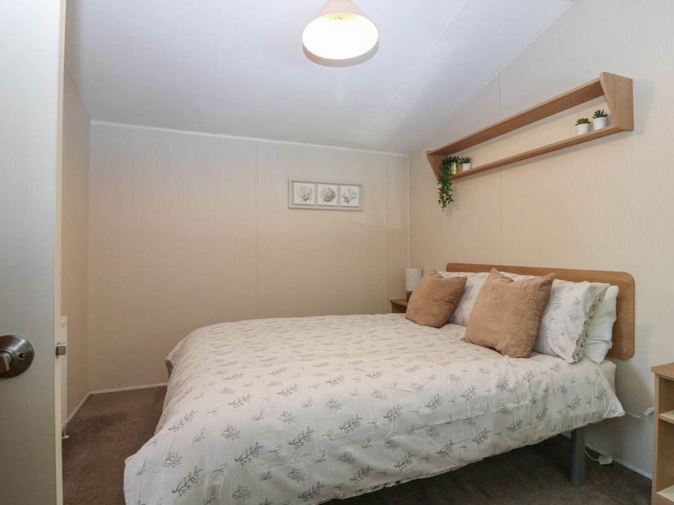 A bedroom with a bed and shelf at NO. 249 in Eyemouth
