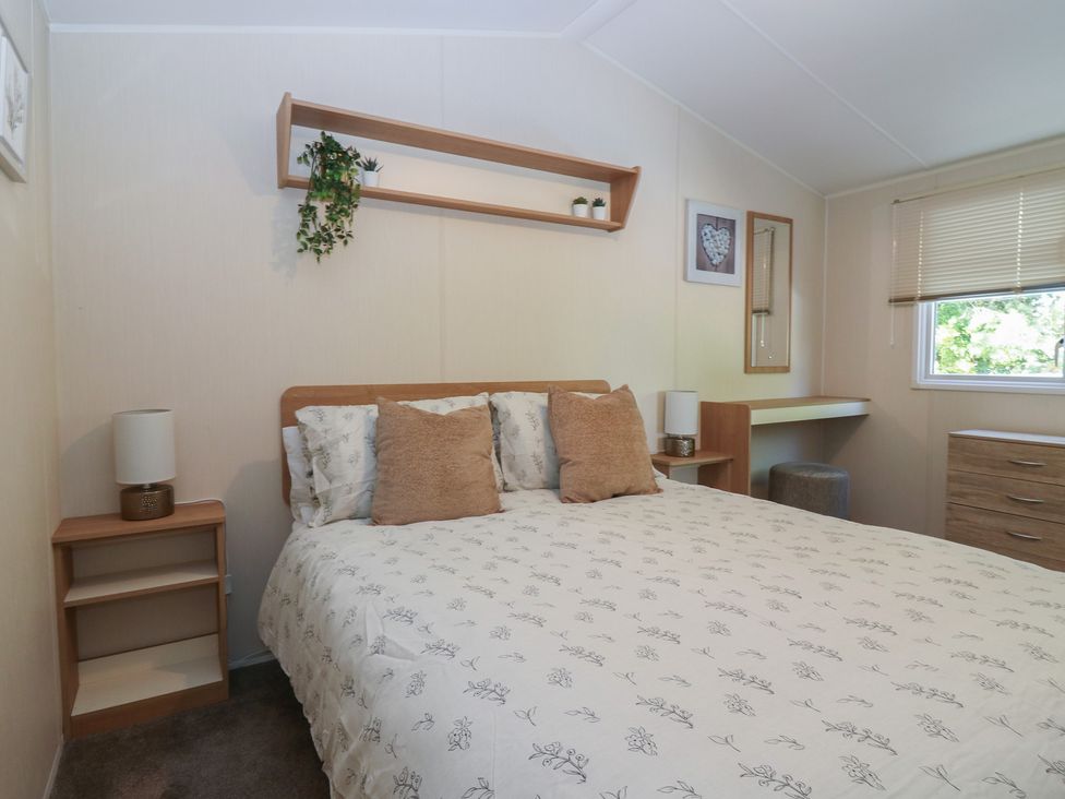 A bedroom with a bed and a shelf at NO. 249, Eyemouth