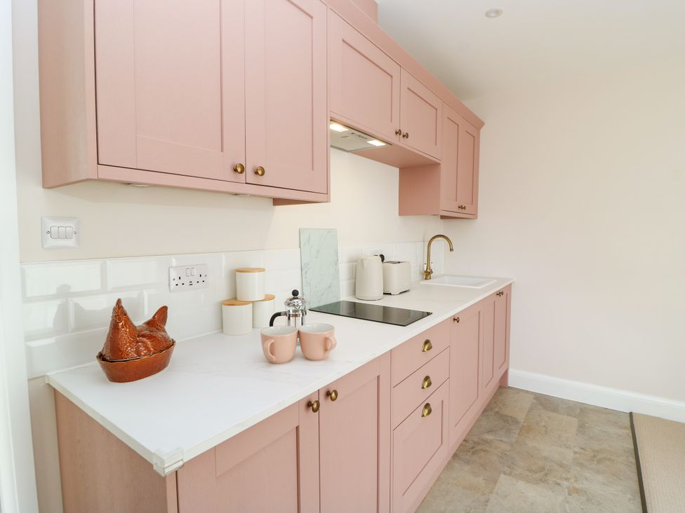 A kitchen with cabinets and a countertop at Kingswick Lodge Naphill