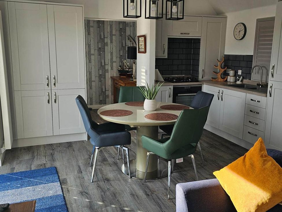 A kitchen with a dining table and chairs at 2 Bed Cottage Sleeps 4 Harbour Sea View Cruden Bay