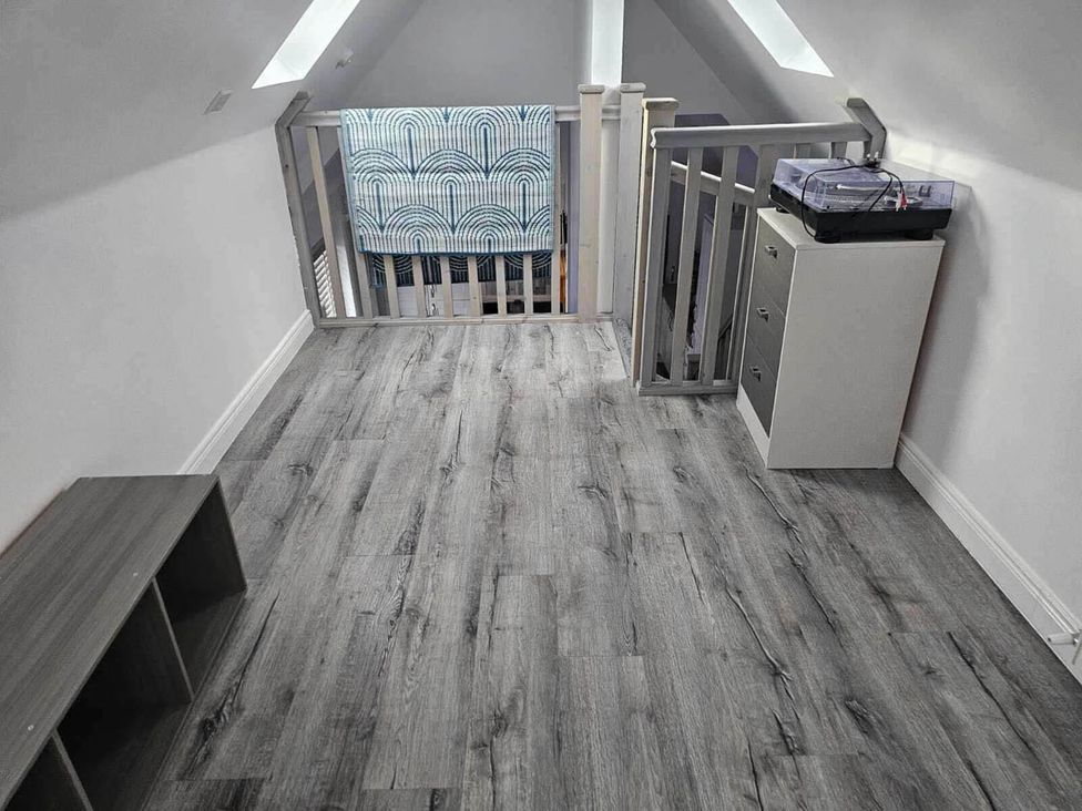 A landing with a cabinet and towel at 2 Bed Cottage Sleeps 4 Harbour Sea View in Cruden Bay