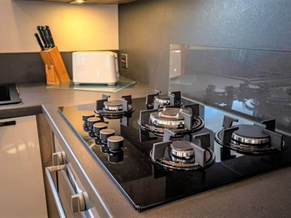 A kitchen with a gas stove and a toaster at Findhorn Lodge Peaceful Sleeps 4 in Forres
