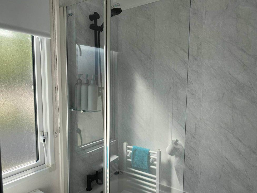 A shower with a towel rail and window at Findhorn Lodge Peaceful Sleeps 4 in Forres