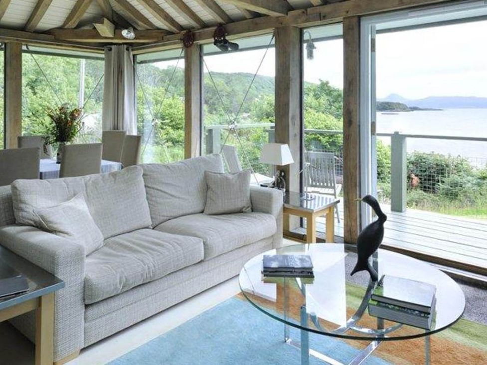 A living room with a sofa and table at Tigh na Mara Sleeps 4 Sea Views Pet Friendly in Drimnin near Lochaline