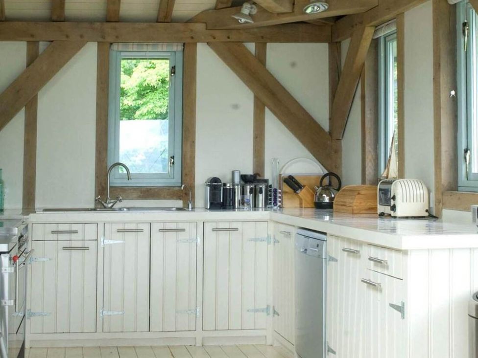 A kitchen with sink, window, cabinets and appliances at Tigh na Mara Sleeps 4 Sea Views Pet Friendly Drimnin near Lochaline