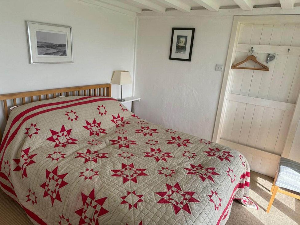 A bedroom with a bed and quilt at Tigh na Mara Sleeps 4 Sea Views Pet Friendly Drimnin near Lochaline