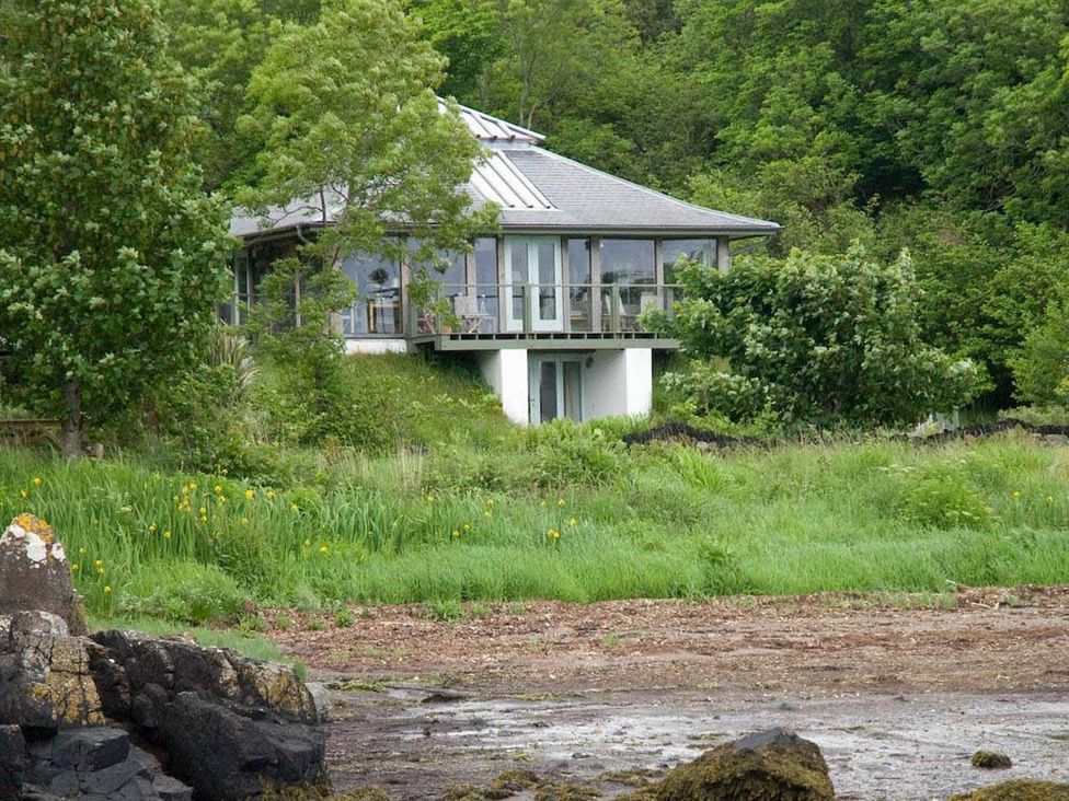 A house surrounded by trees and grass at Tigh na Mara Sleeps 4 Sea Views Pet Friendly Drimnin near Lochaline