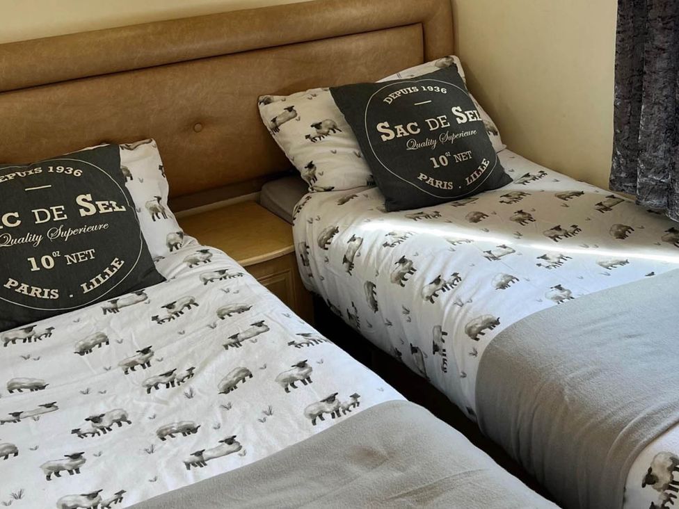 A bedroom with two beds and pillows at Sea Breeze A Beautiful 3 Bed Pet Friendly Retreat Mablethorpe