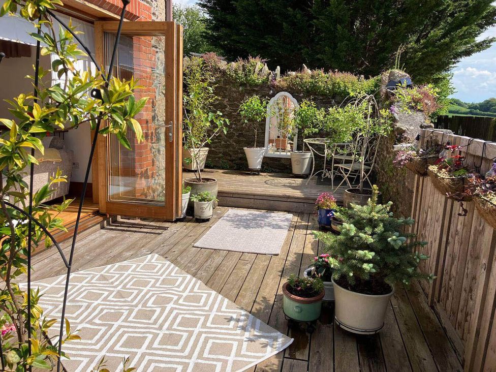 An outdoor area with plants and seating at The Old Chapel of Ermington in Ermington