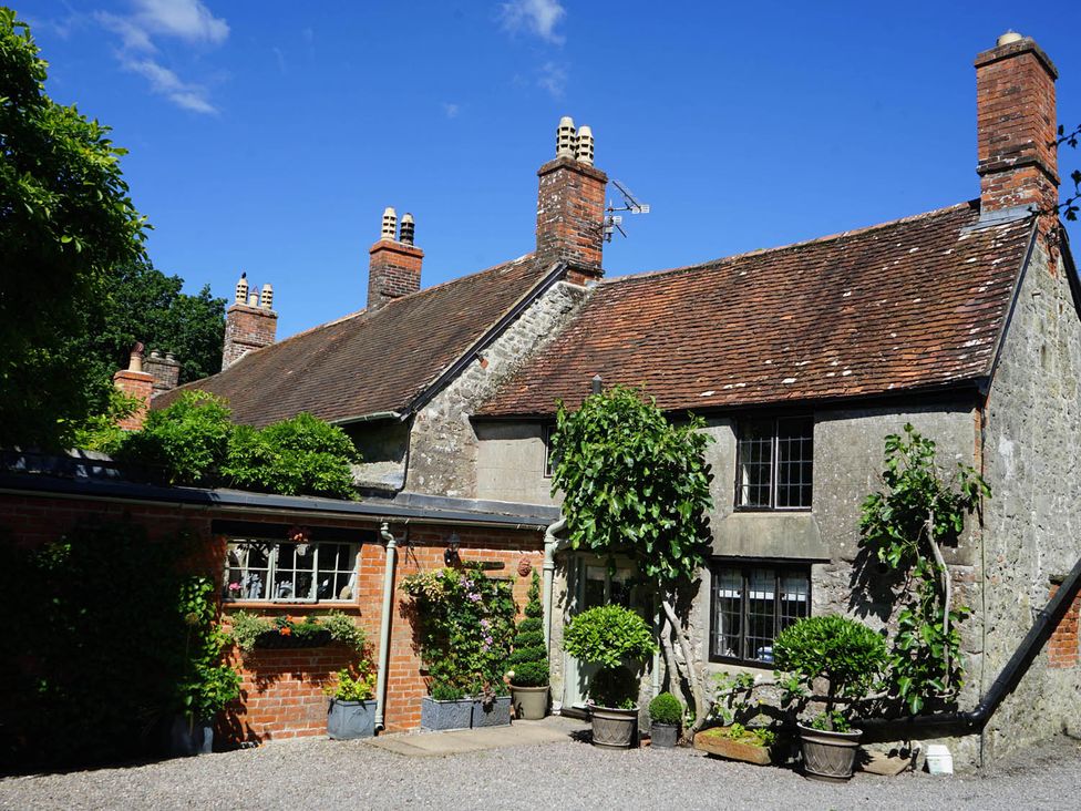 A house with chimneys and planters in an outdoor area at the property