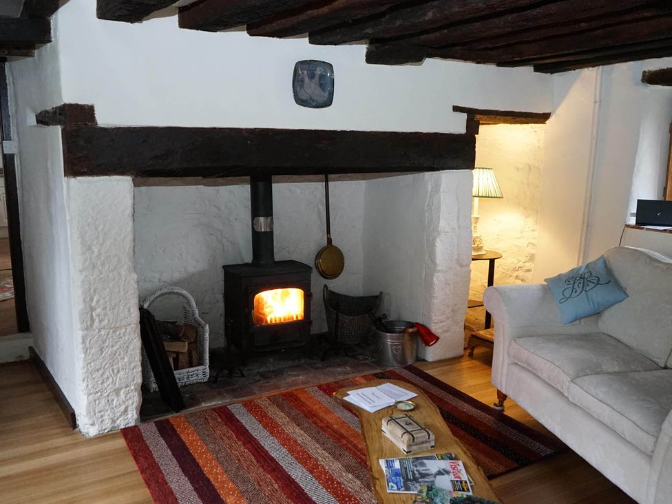 A living room with a fireplace and sofa at the property in the location