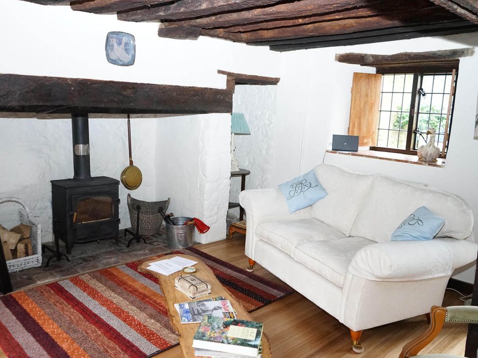 A living room with a couch and wood stove at The Old Barn in Manchester