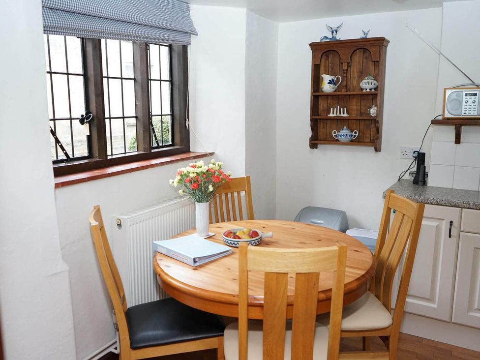 A kitchen with a round table and chairs at a property
