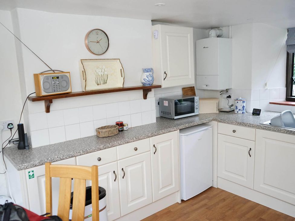 A kitchen with a microwave and refrigerator at The Old Barn in Manchester