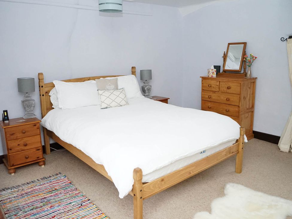 A bedroom with a bed and nightstands at the property in the location