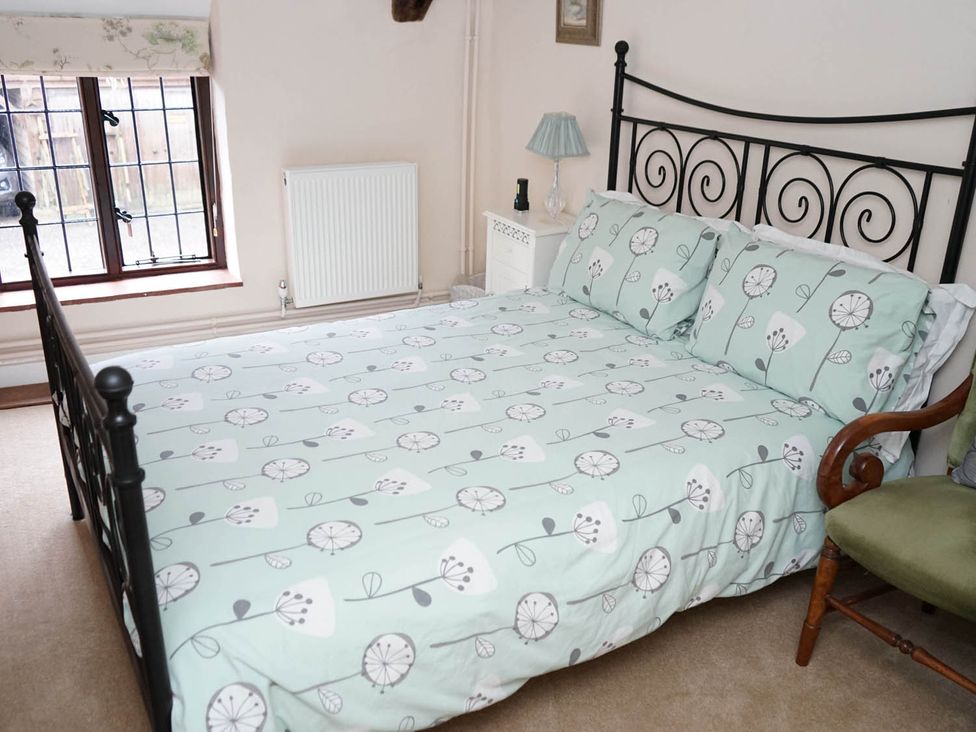 A bedroom with a bed and lamp at The Old Barn in Manchester