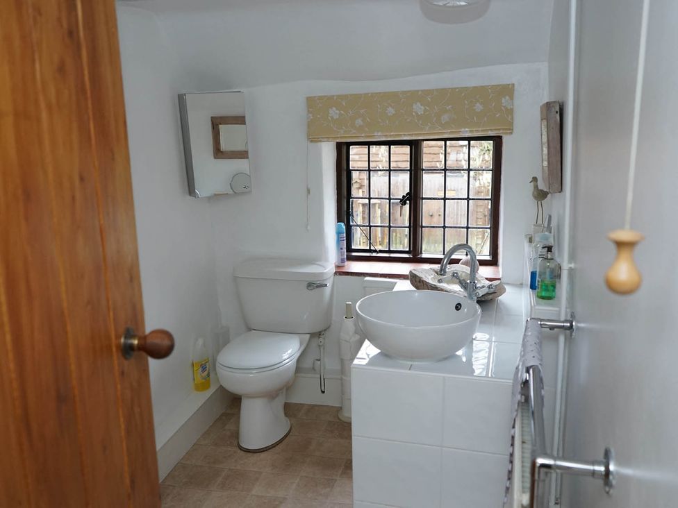 A bathroom with a toilet and washbasin at The Old Barn in Manchester