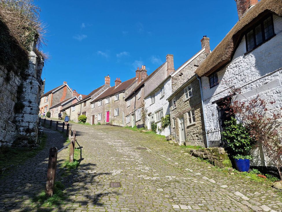 A street with houses on a hill at a village