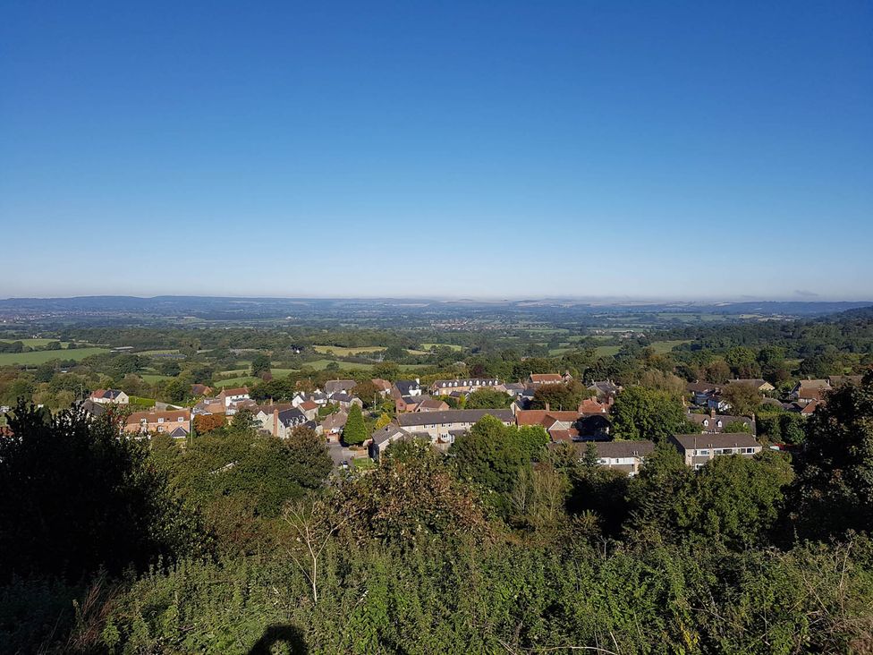 A view of houses and fields under a clear sky